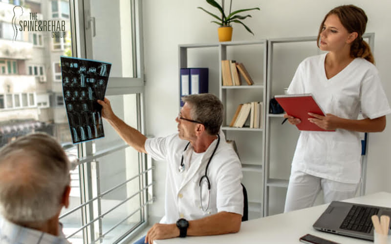 Doctor consulting with patient presenting results on x-ray film About the problem of the patient